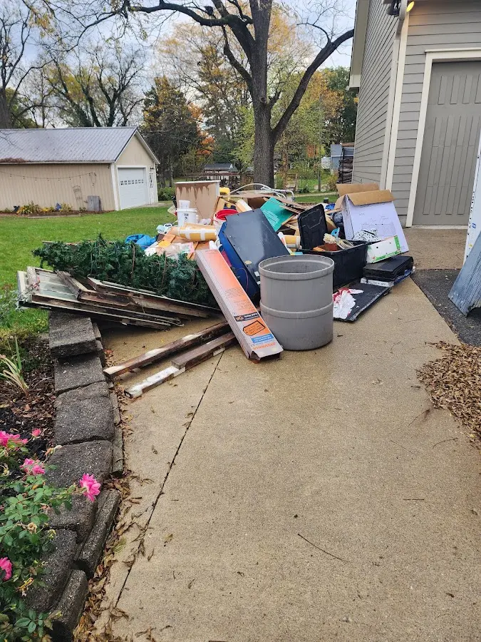 Dumpster being loaded with debris for Roofing Dumpster Rental in Cedar Mill